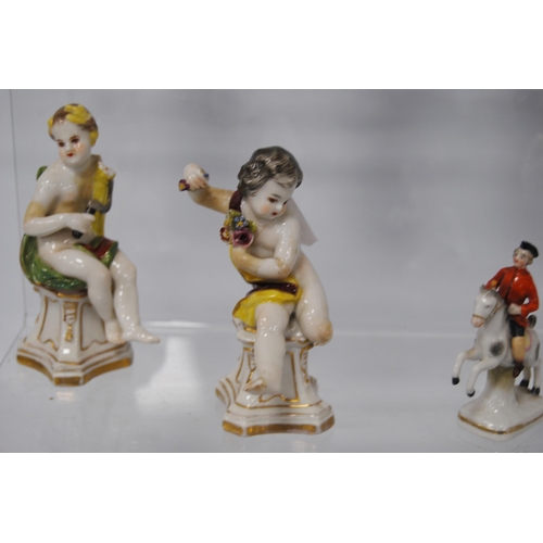 218 - Pair of 19th century Naples porcelain figures modelled as scantily-clad putti with a bird and dog, 1... 