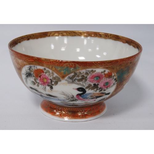 196 - Japanese Kutani bowl in typical colours, decorated with panels of birds and floral sprays to the wel... 