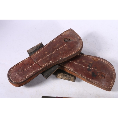 102 - Pair of Eastern leather and stitched thread sandals, 27cm long, a Chinese style two section carved b... 