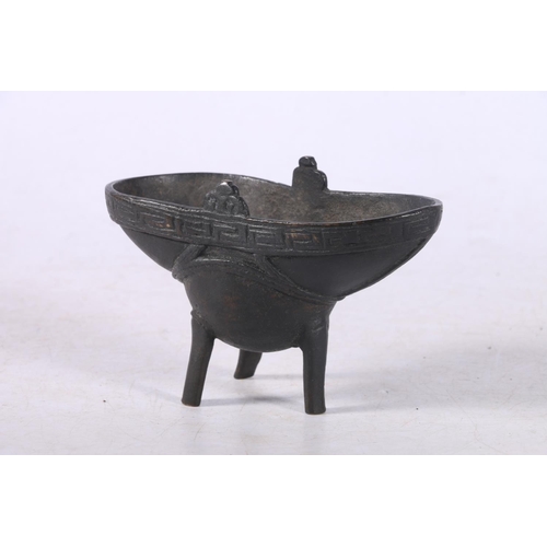 103 - Chinese cast bronze libation cup of typical form with Greek Key style border, raised on three suppor... 