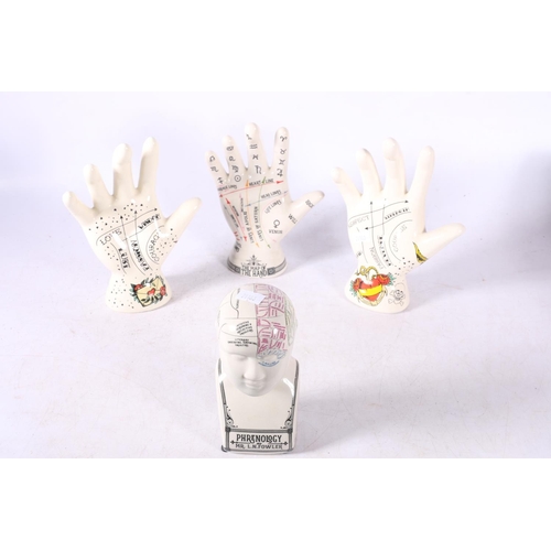 106 - Three reproduction palmistry hands and a reproduction L N Fowler phrenology head.  (4)