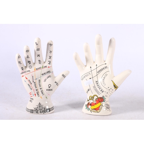 106 - Three reproduction palmistry hands and a reproduction L N Fowler phrenology head.  (4)