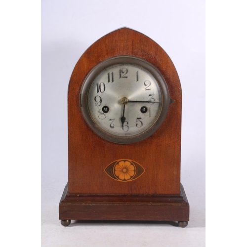 108 - Mahogany cased arch-top mantel clock decorated with faux inlaid flower to front, 30cm high.