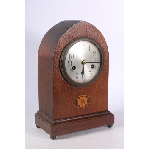 108 - Mahogany cased arch-top mantel clock decorated with faux inlaid flower to front, 30cm high.