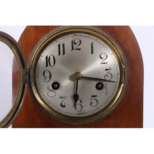 108 - Mahogany cased arch-top mantel clock decorated with faux inlaid flower to front, 30cm high.