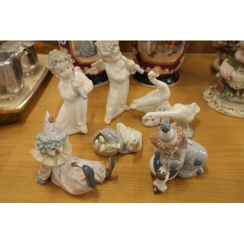 129 - Lladro figurines to include clowns, cherubs, and geese.  (7)