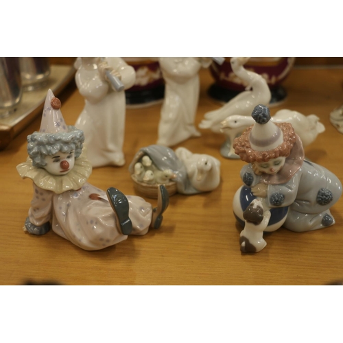 129 - Lladro figurines to include clowns, cherubs, and geese.  (7)