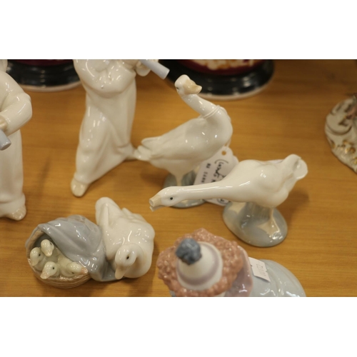 129 - Lladro figurines to include clowns, cherubs, and geese.  (7)