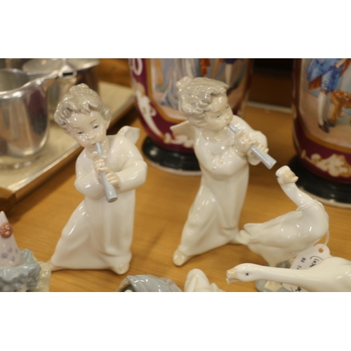 129 - Lladro figurines to include clowns, cherubs, and geese.  (7)