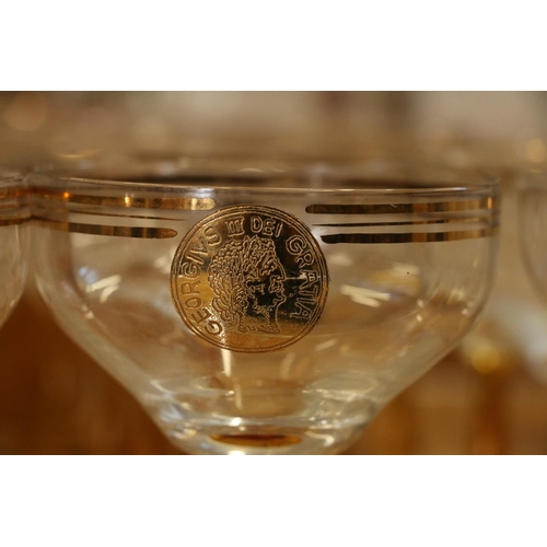 140 - Amber and clear drinking glasses with gilded coin decoration.