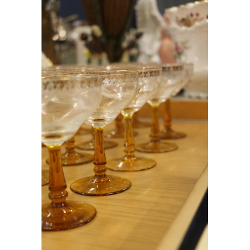 140 - Amber and clear drinking glasses with gilded coin decoration.