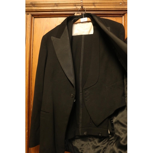 143 - Black three-piece tailored suit.