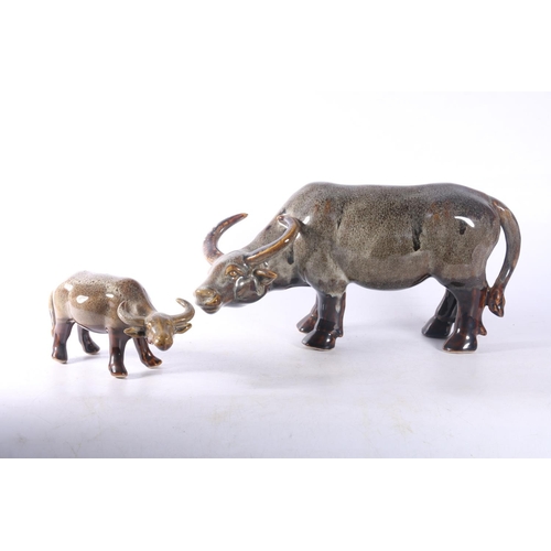 15 - Two ceramic buffalo models.