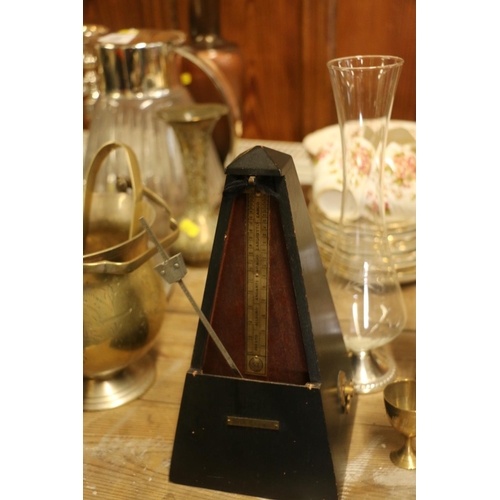 161 - Black painted metronome, brassware, and a glass vase.