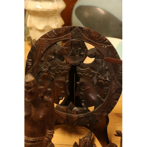 167 - Southeast Asian/Indonesian carved wooden items to include a wall plaque, tribal figures, etc.