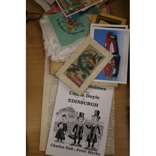 219 - Postcards, stamps and ephemera to include silk embroidered cards, a book 'Sherlock Holmes in Edinbur... 