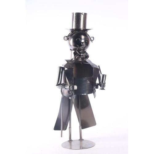 25 - Novelty wine bottle holder in the form of a gentleman in tuxedo and top hat, and a model of an early... 