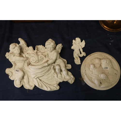 30 - Three plaster cast cherubs, largest 30cm wide.