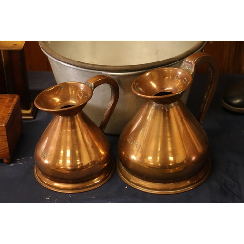 31 - Two copper measuring jugs and an aluminium jelly pan.