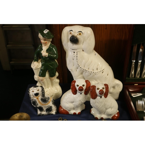 35 - Four wally dogs and a Staffordshire style model of a boy standing, 34cm high.