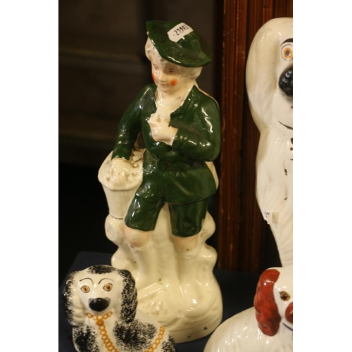 35 - Four wally dogs and a Staffordshire style model of a boy standing, 34cm high.