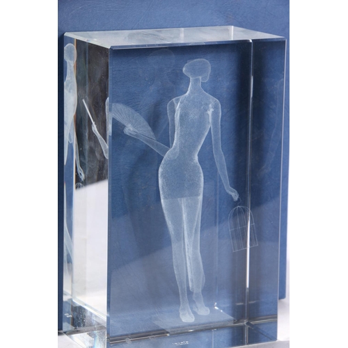 46 - Lafeye glass block internal 3D dot sculpture of a lady with fan, together with a similar presentatio... 