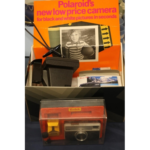 51 - Polaroid Super Swinger camera and a Kodak Instamatic 33 camera.