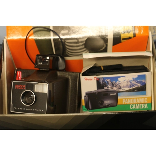 51 - Polaroid Super Swinger camera and a Kodak Instamatic 33 camera.