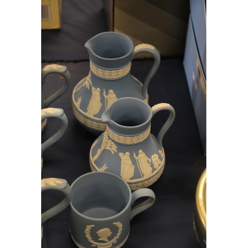 65 - Wedgwood Jasper Ware to include six tankards, two water jugs, and a smaller commemorative cup.