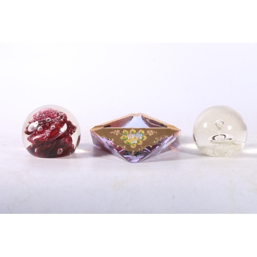 73 - Two Selkirk Glass paperweights and a Bohemian faceted glass ashtray.