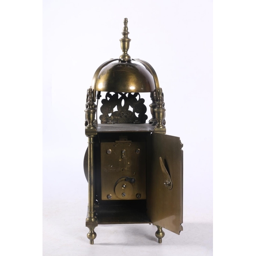 78 - Brass lantern clock decorated with pierced panels depicting dolphins amongst sea foliage, 29cm.