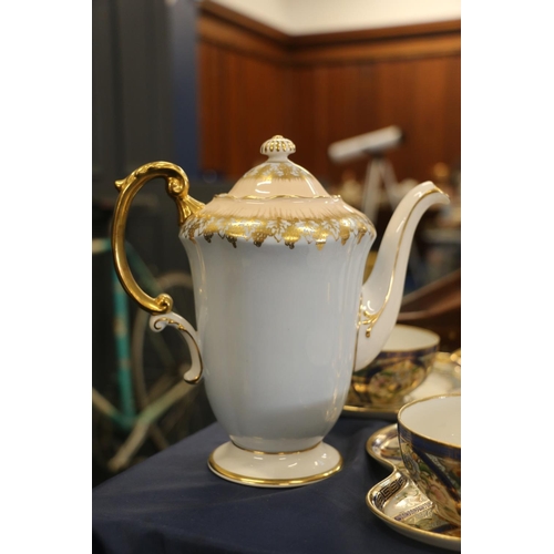 81 - Six Noritake floral decorated tennis sets, and a Paragon blue and gilt decorated coffee pot.