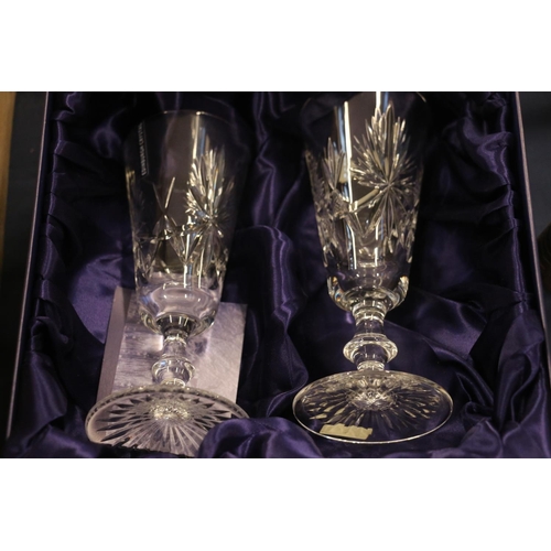 86 - Six Edinburgh Crystal wine glasses, boxed, and two Edinburgh Crystal champagne flutes, also boxed.