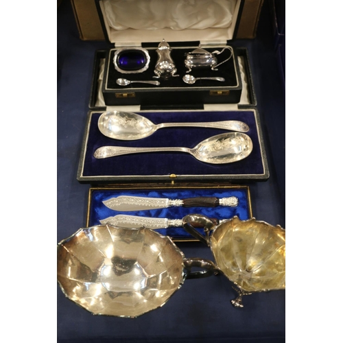 87 - EPNS flatware to include serving spoons, a cruet set and a cream jug and sugar dish.