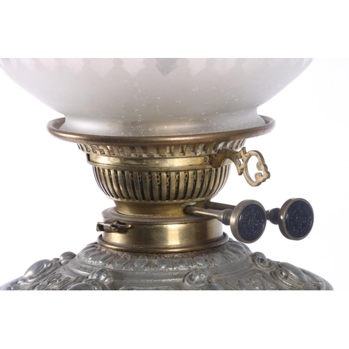 9 - David Foulis of Edinburgh cast metal and glass oil lamp, decorated with repousse masks and scrolls, ... 