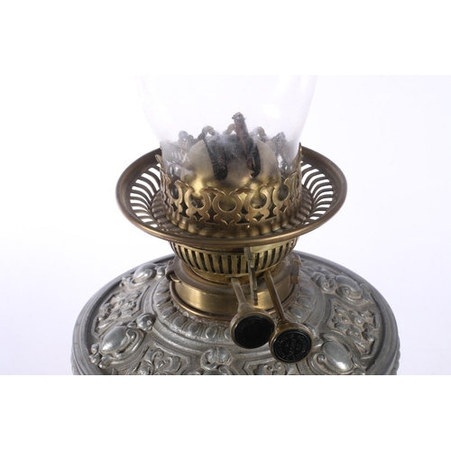 9 - David Foulis of Edinburgh cast metal and glass oil lamp, decorated with repousse masks and scrolls, ... 