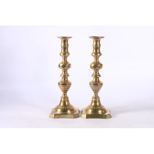 92 - Pair of brass candlesticks.