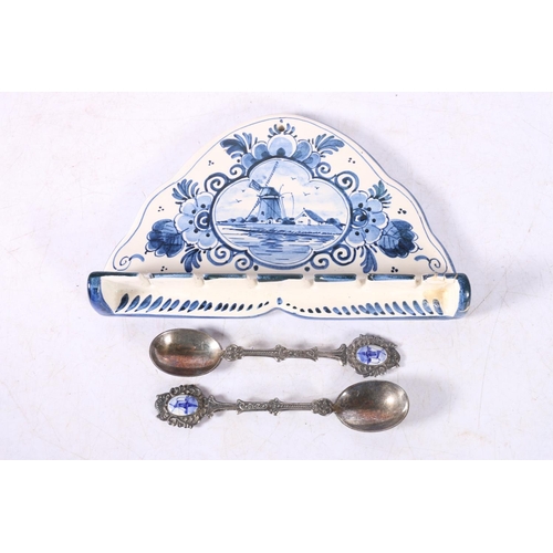 94 - Delft of Holland souvenir spoon rack with two souvenir spoons.