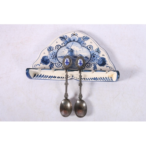 94 - Delft of Holland souvenir spoon rack with two souvenir spoons.