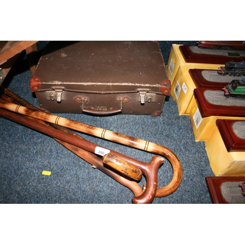 200 - Vintage leather case and four walking sticks.