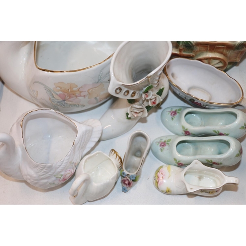 124 - Decorative ceramics to include miniature shoes, floral decorated plant pots, etc.