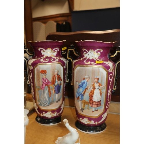 128 - Pair of continental porcelain vases decorated with classical scenes, 33cm high.