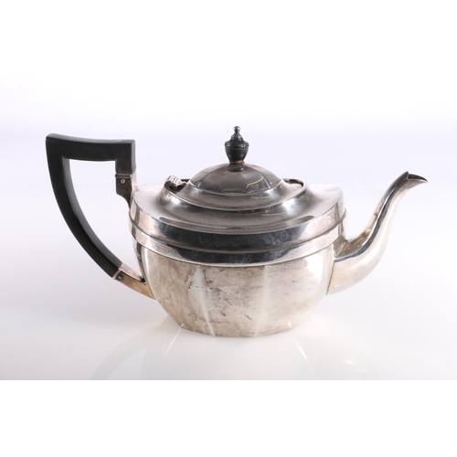 18 - George V hallmarked silver three-piece tea set, the faceted shaped teapot with ebony finial and angu... 