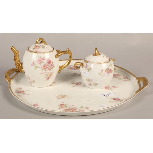 233 - Limoges floral and gilt decorated teapot and sugar bowl on a twin handled circular tray.