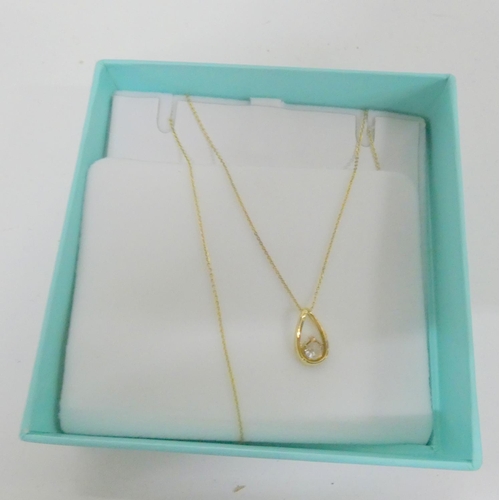 413 - 9ct gold zirconia pendant and chain. 1.7g