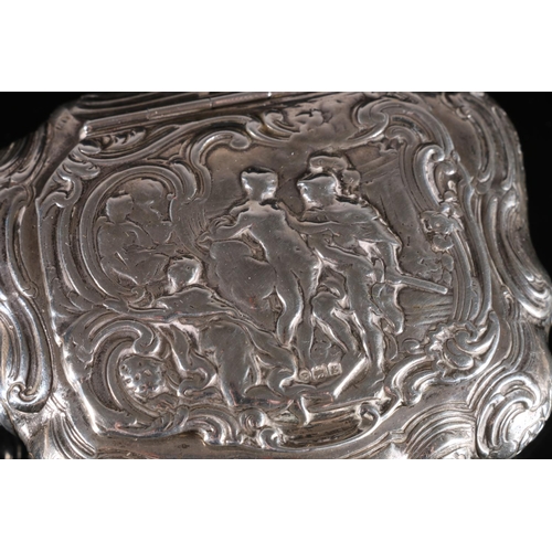 102 - Continental silver table tobacco box of cartouche form, the hinged cover decorated in relief with cl... 