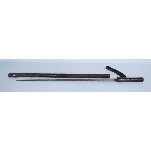 263 - Antique sword stick contained in a tooled leather scabbard with truncheon strap, blade length 51cm.