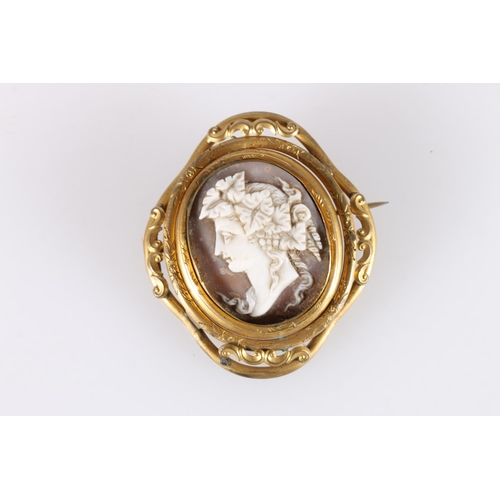 524 - Late Victorian cameo shell brooch in pinchbeck mount, the rear with glazed panel containing woven ha... 