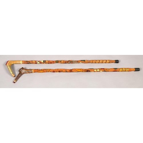 202 - Two Swiss carved walking sticks