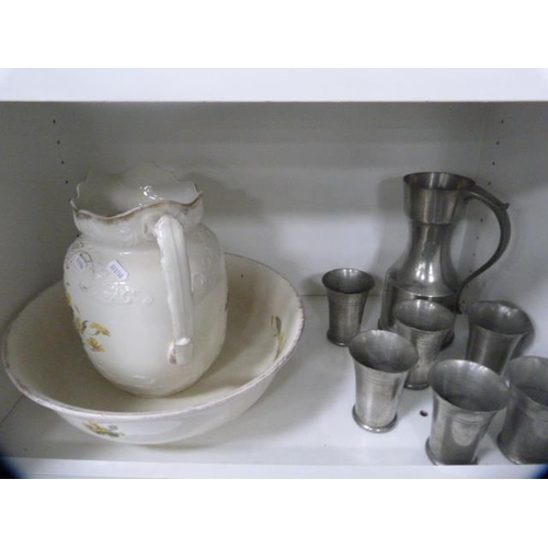 112 - Ceramic toilet ewer and basin and a pewter water set (one shelf).